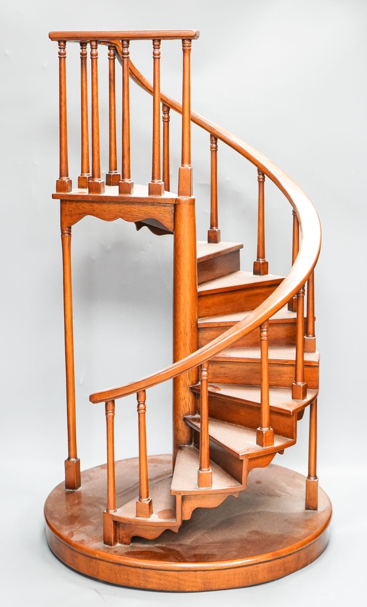 A large mahogany model of a spiral staircase 61cm